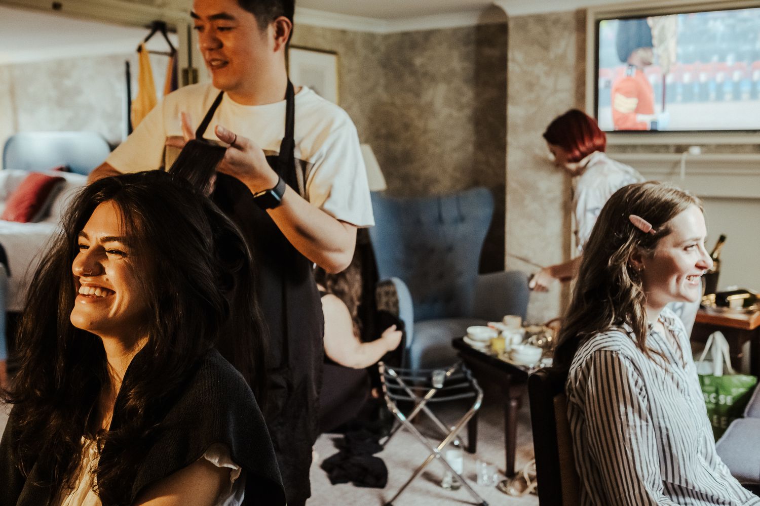 Friends gathered in a cozy room for pre-wedding preparations.
