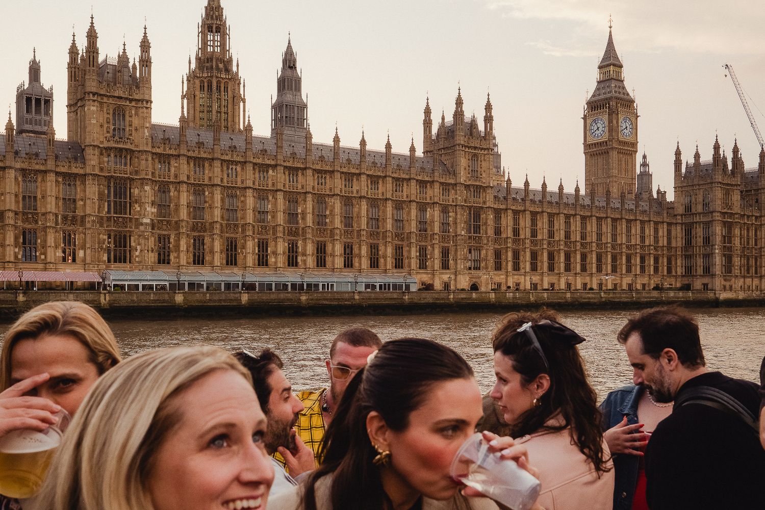 Westminster Palace and Big Ben tower stand majestically along the Thames River in London.