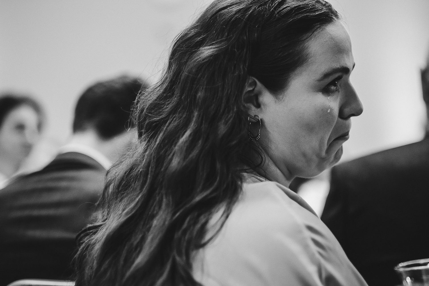Black and white portrait captures emotional moment at wedding celebration.