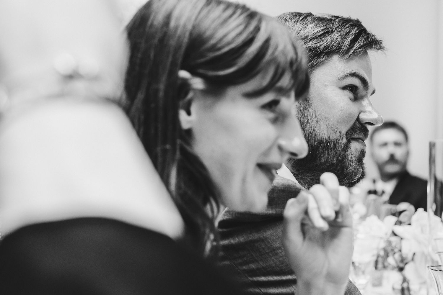 Black and white candid shots of guests caught in moments of laughter.
