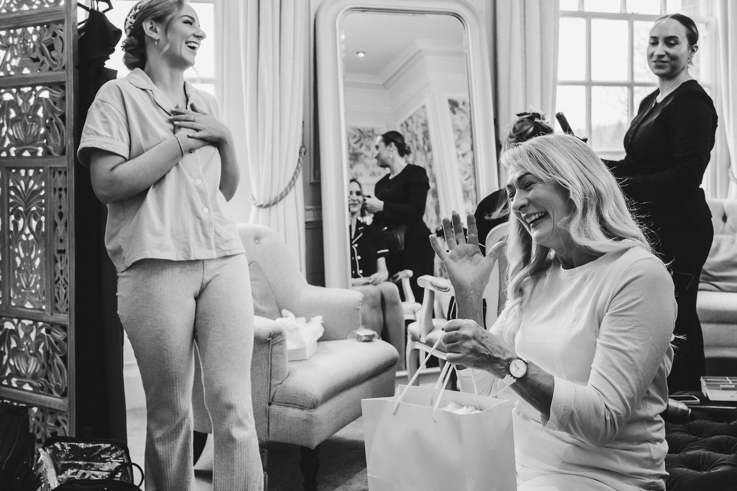 Wedding party preparations in a bright indoor venue with natural window light.