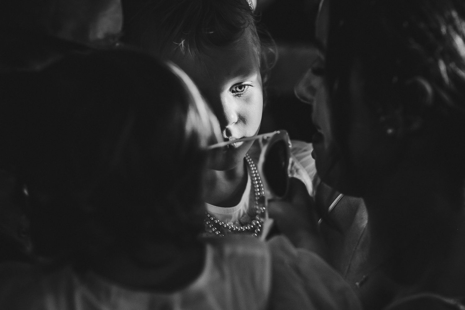 Dramatic black and white close-up portrait with moody lighting and shadows.