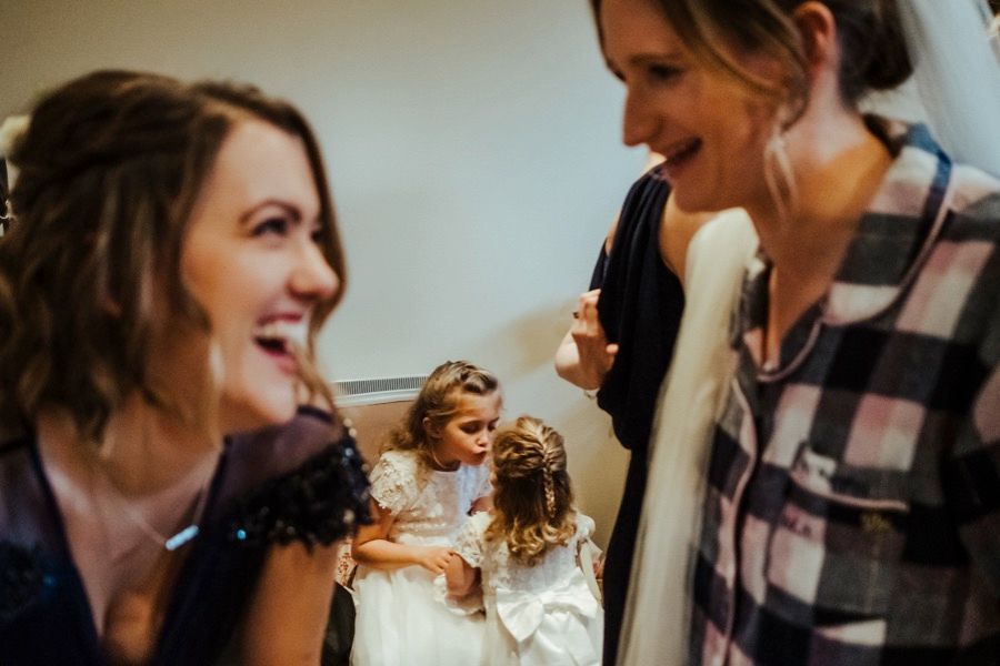 Wedding guests share a candid moment of laughter during the celebration.