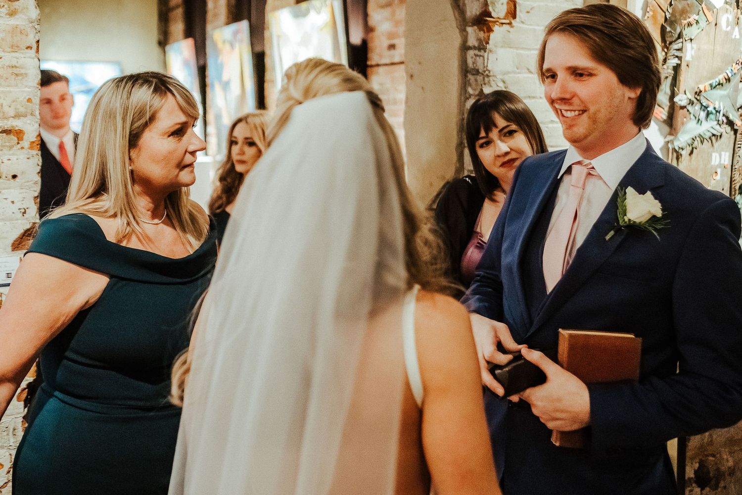 Wedding guests sharing joyful conversations during an elegant indoor celebration.