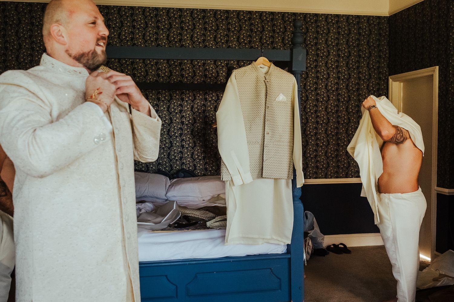 A series of photos show a person putting on a light-colored dress shirt while getting dressed in a blue-toned room.