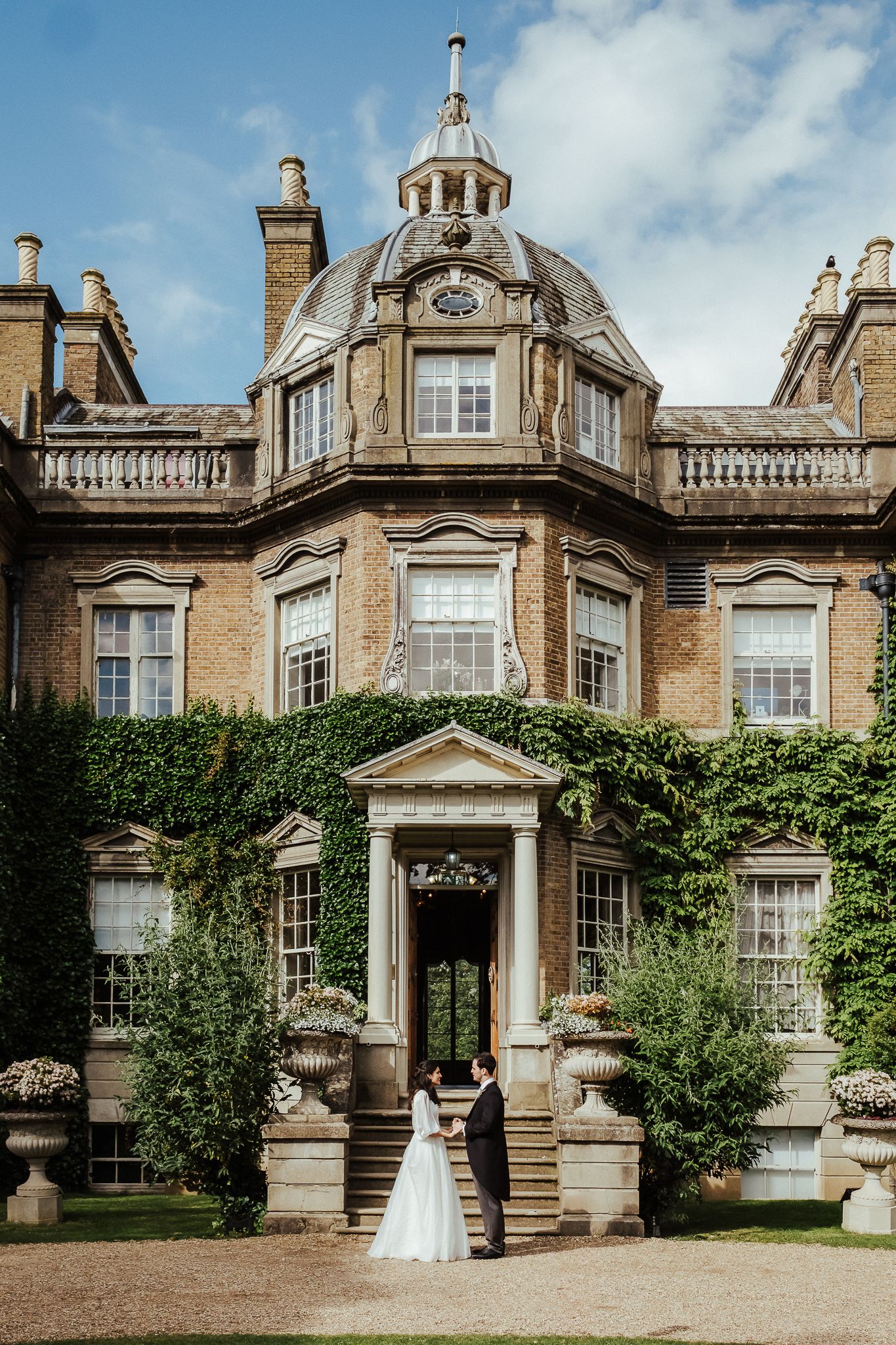 Majestic Victorian mansion wedding venue with ornate architecture and landscaped grounds.