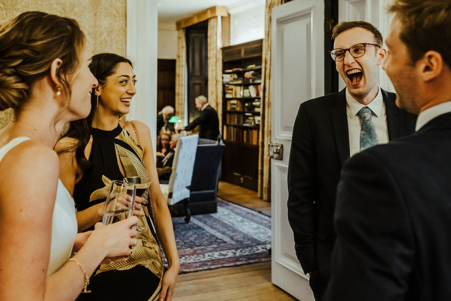 Candid moments of laughter and conversation at an elegant indoor wedding reception.