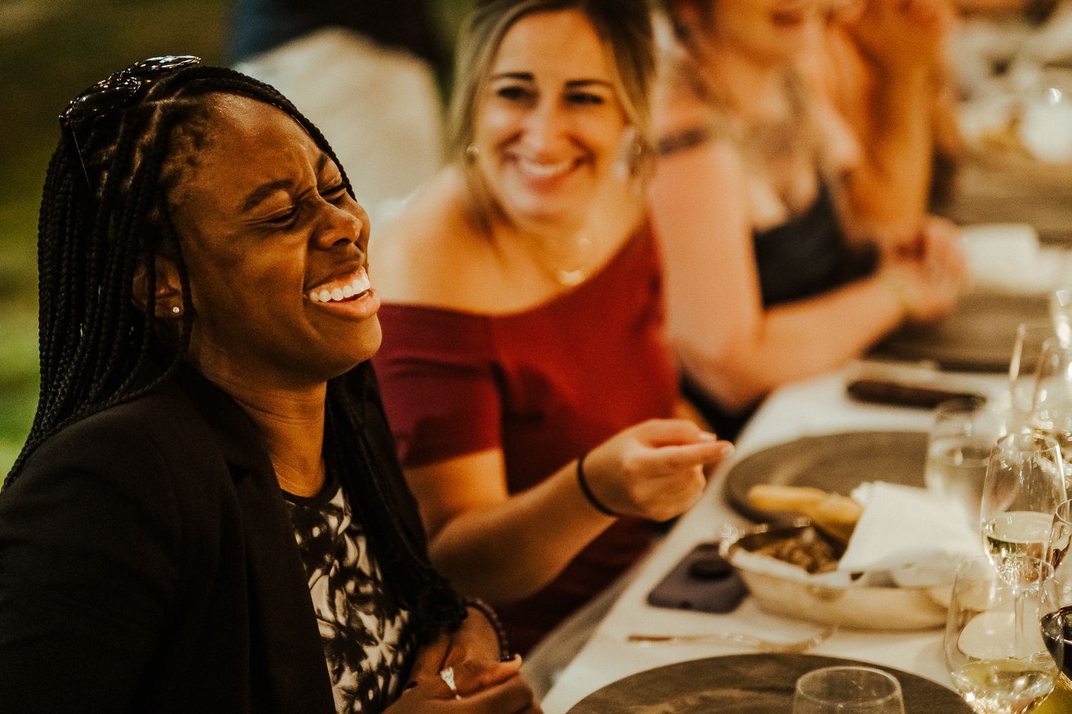 Guests share joyful moments during an outdoor dinner celebration.