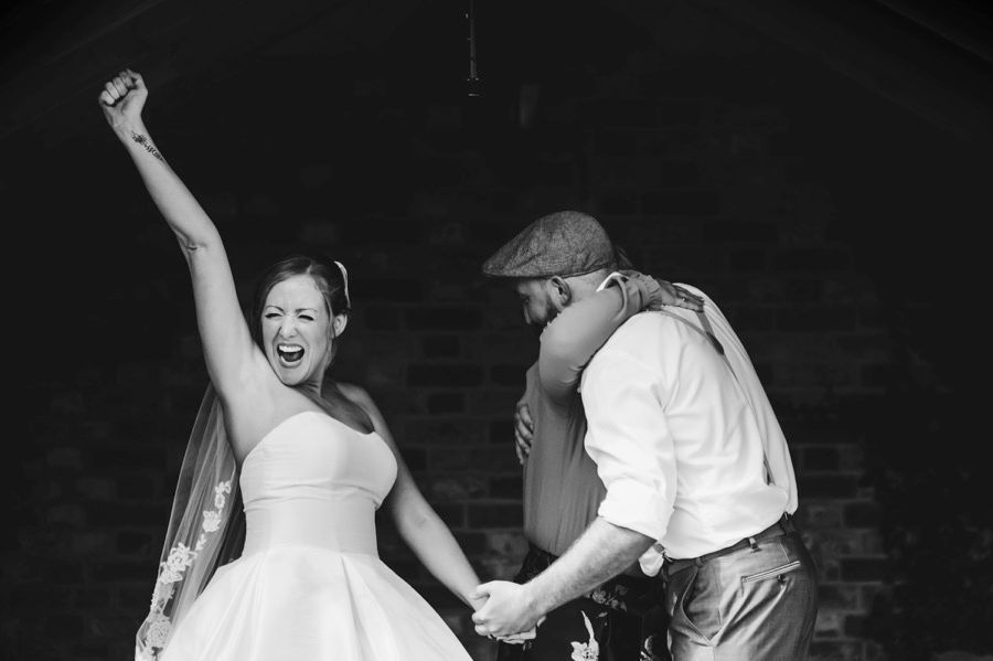 Black and white dance floor photos showing wedding guests celebrating with energetic dance moves.