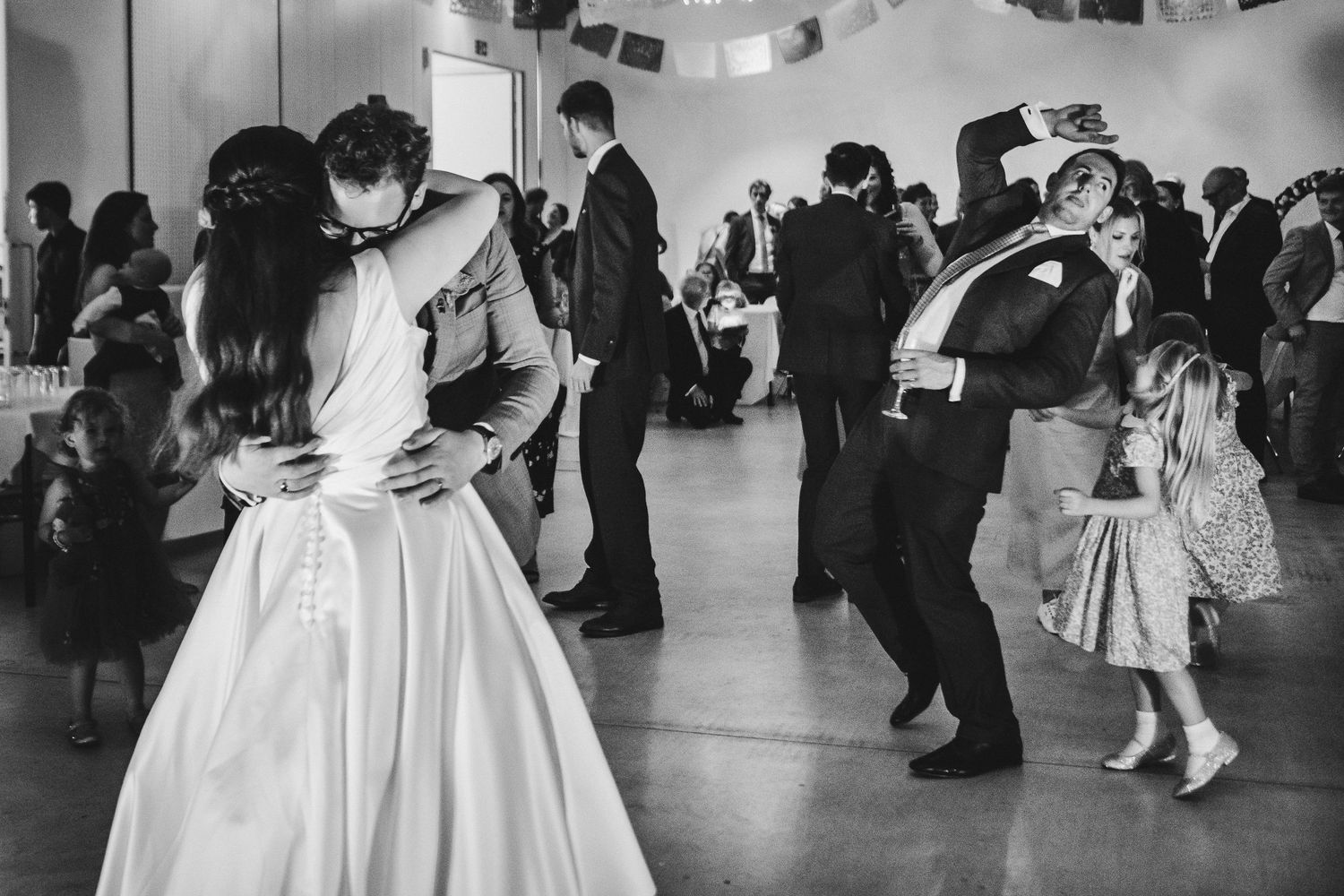 Couples dancing at a wedding reception in black and white with a vintage aesthetic.