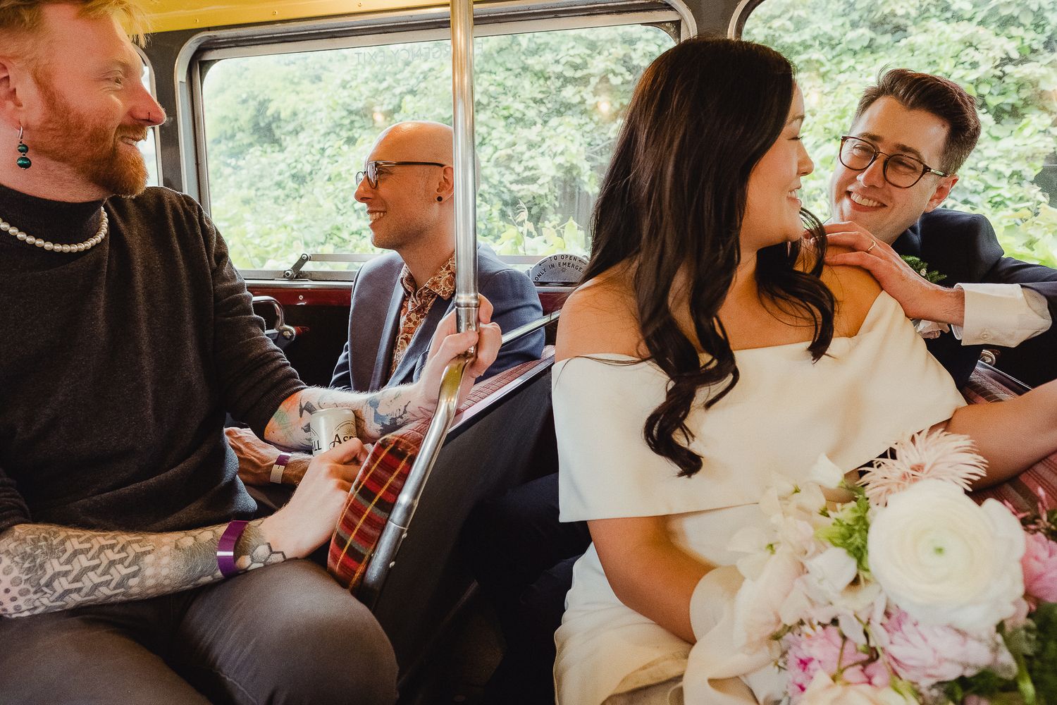 Newlyweds and guests ride together in a vintage car with musical instruments and bouquet during wedding celebration.