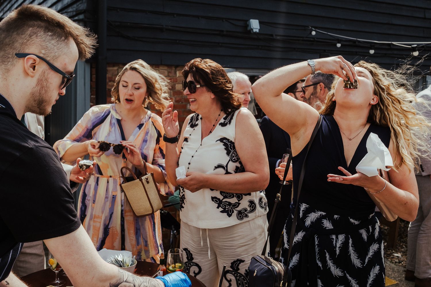 Friends share an emotional embrace during a wedding celebration.