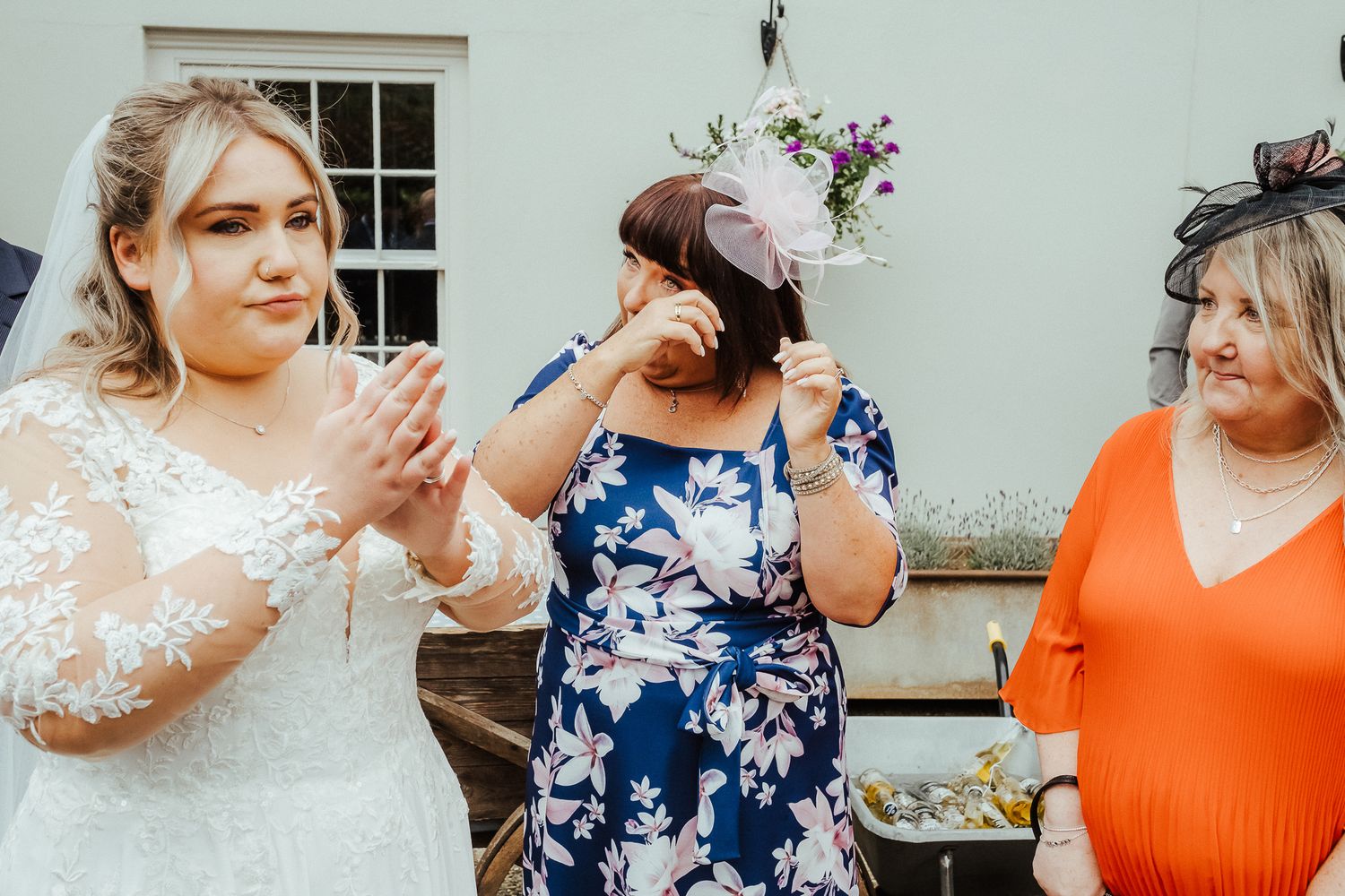 Wedding guests sharing laughter and excitement during an outdoor reception.