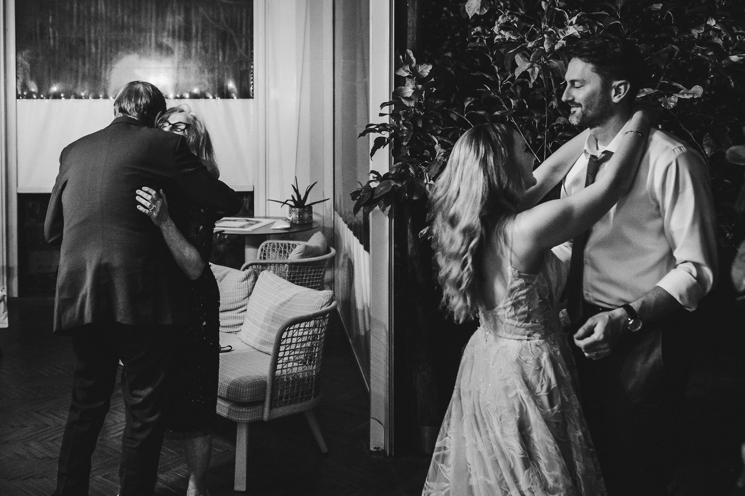 Wedding reception dance party captured in dramatic black and white photography.