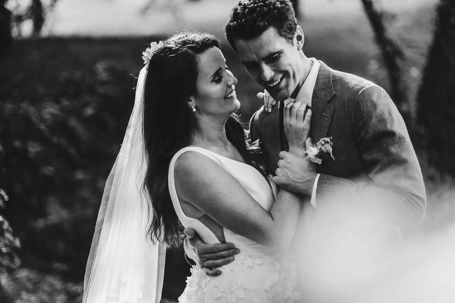Black and white wedding portraits capture intimate romantic moments outdoors.