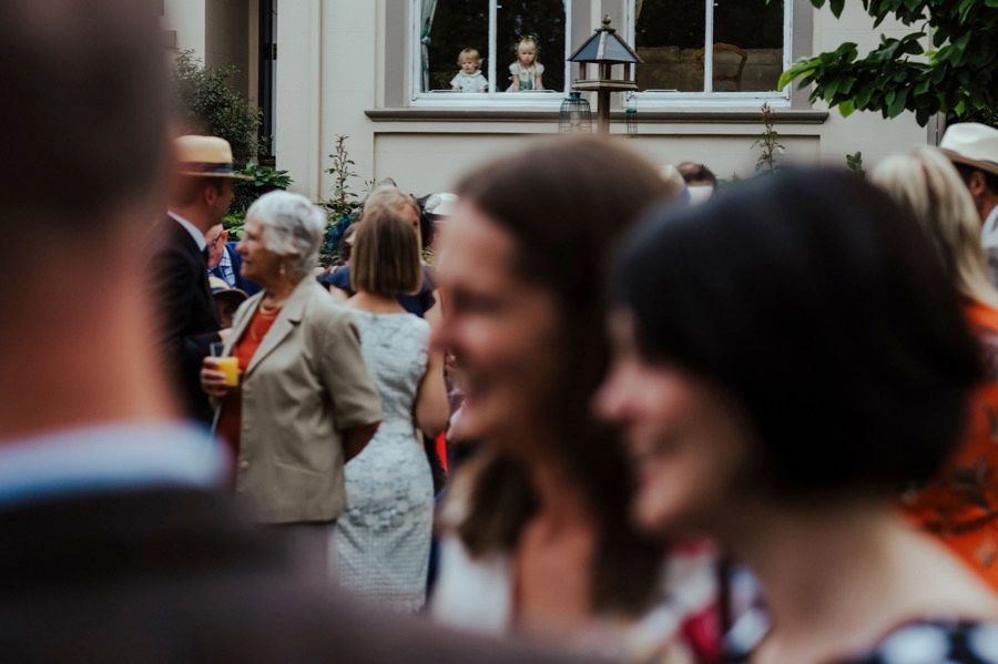 Wedding guests mingle during an outdoor reception celebration.