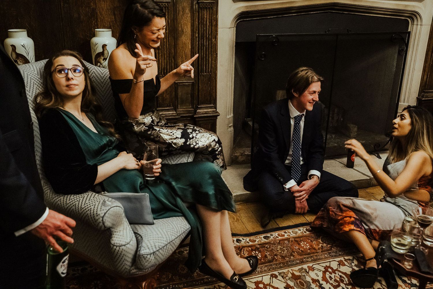 Guests relaxing in a vintage sitting room during an elegant evening gathering.
