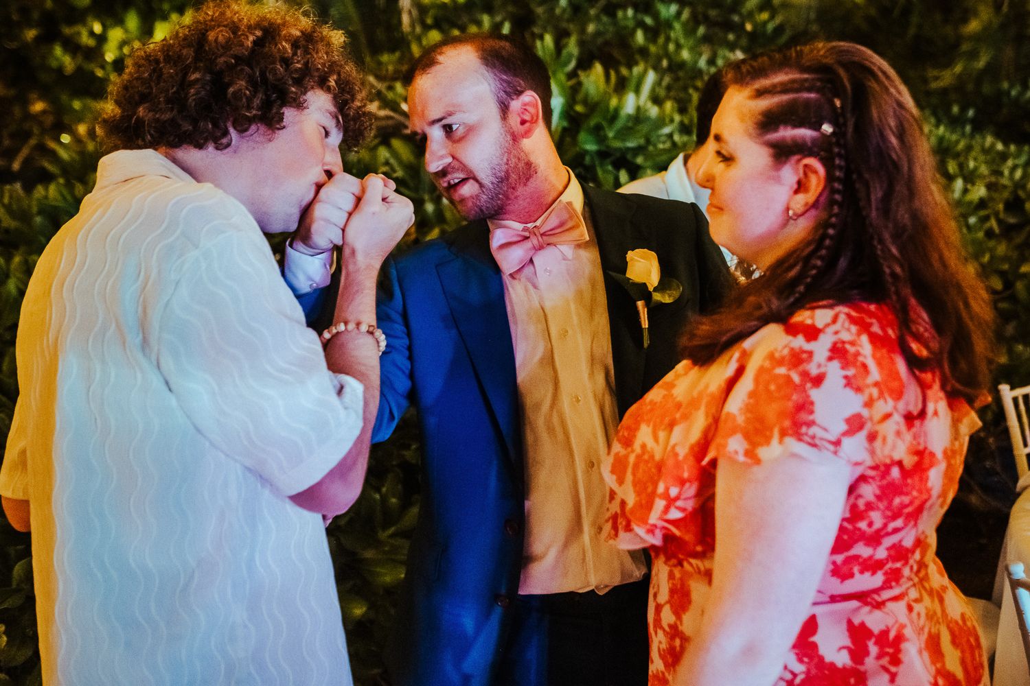 A dance celebration outdoors with string lights and colorful attire.