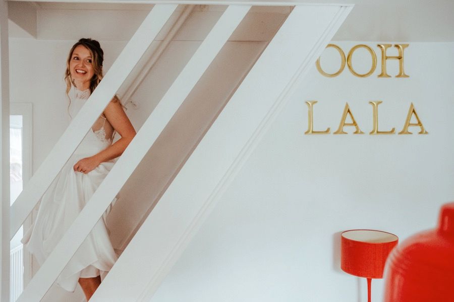 White interior room with golden lettering on the wall and natural lighting.