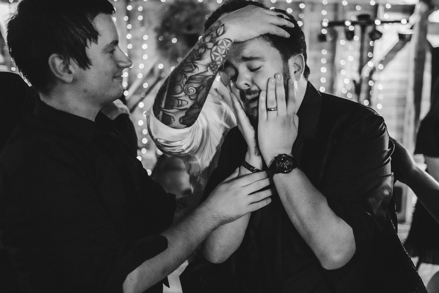 Emotional celebratory moment captured in black and white at evening event.