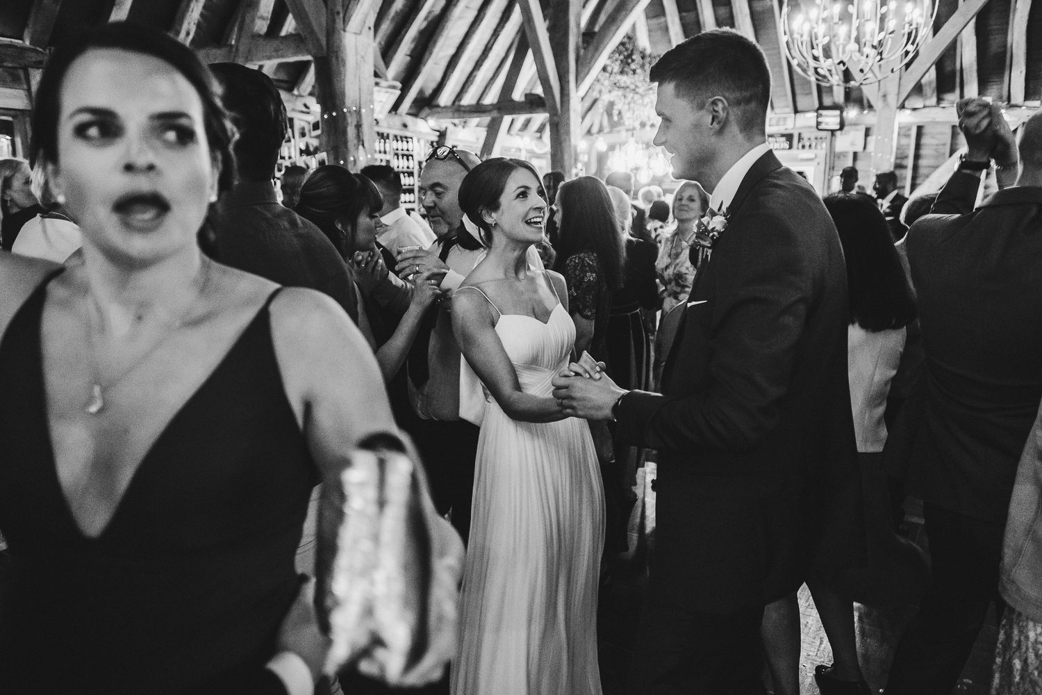 Black and white photo of wedding reception dancing and celebrations.