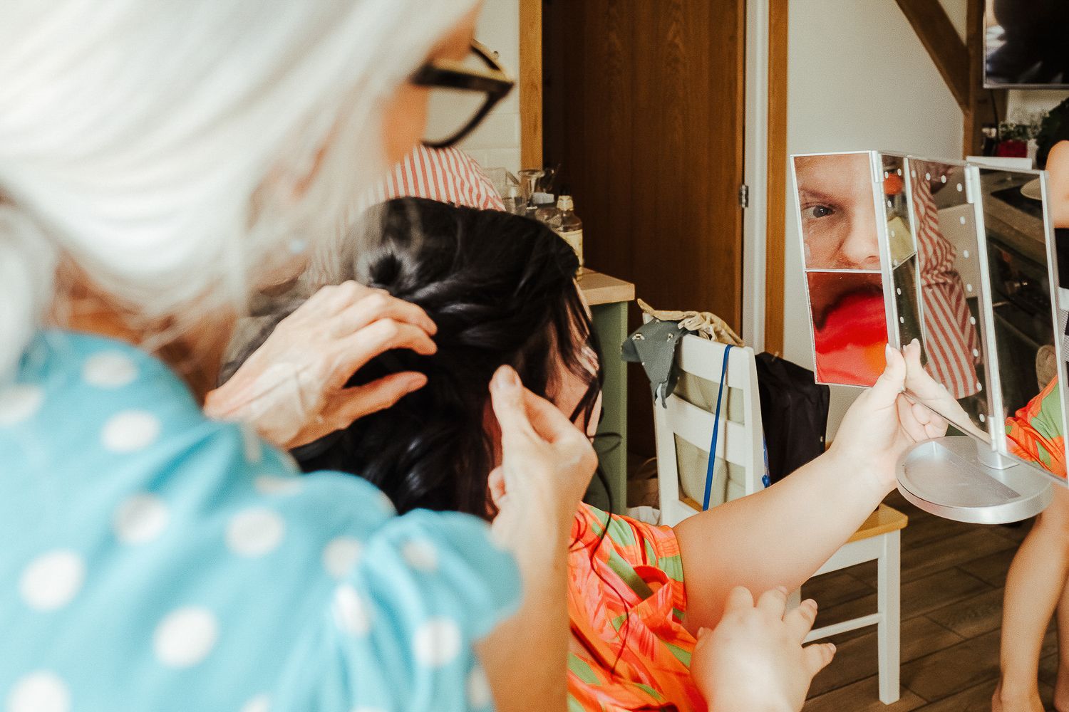 Close-up shot of wedding preparation with styling tools and mirrors.