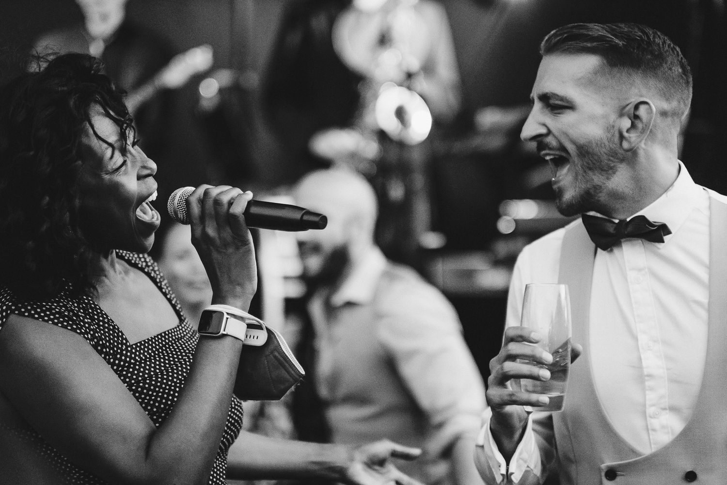 Wedding guests dance and celebrate at a lively reception party.