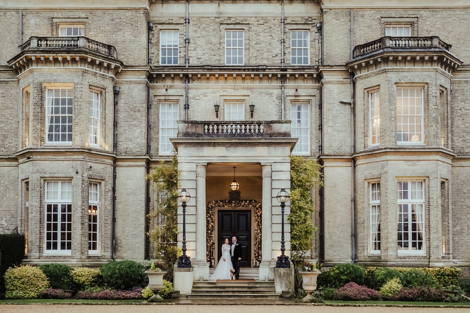 Historic mansion exterior with classic architecture serves as wedding venue backdrop.