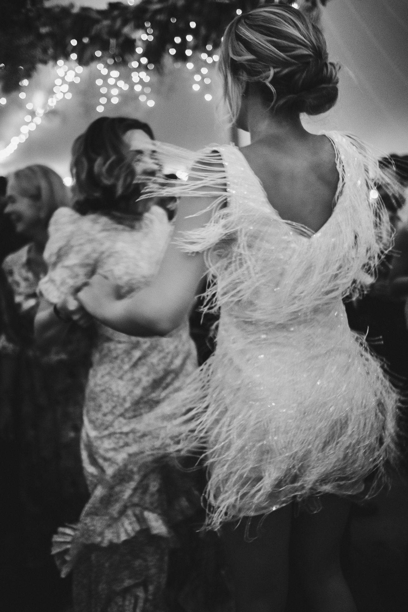 Black and white photo showing dynamic dance movements with flowing dresses.