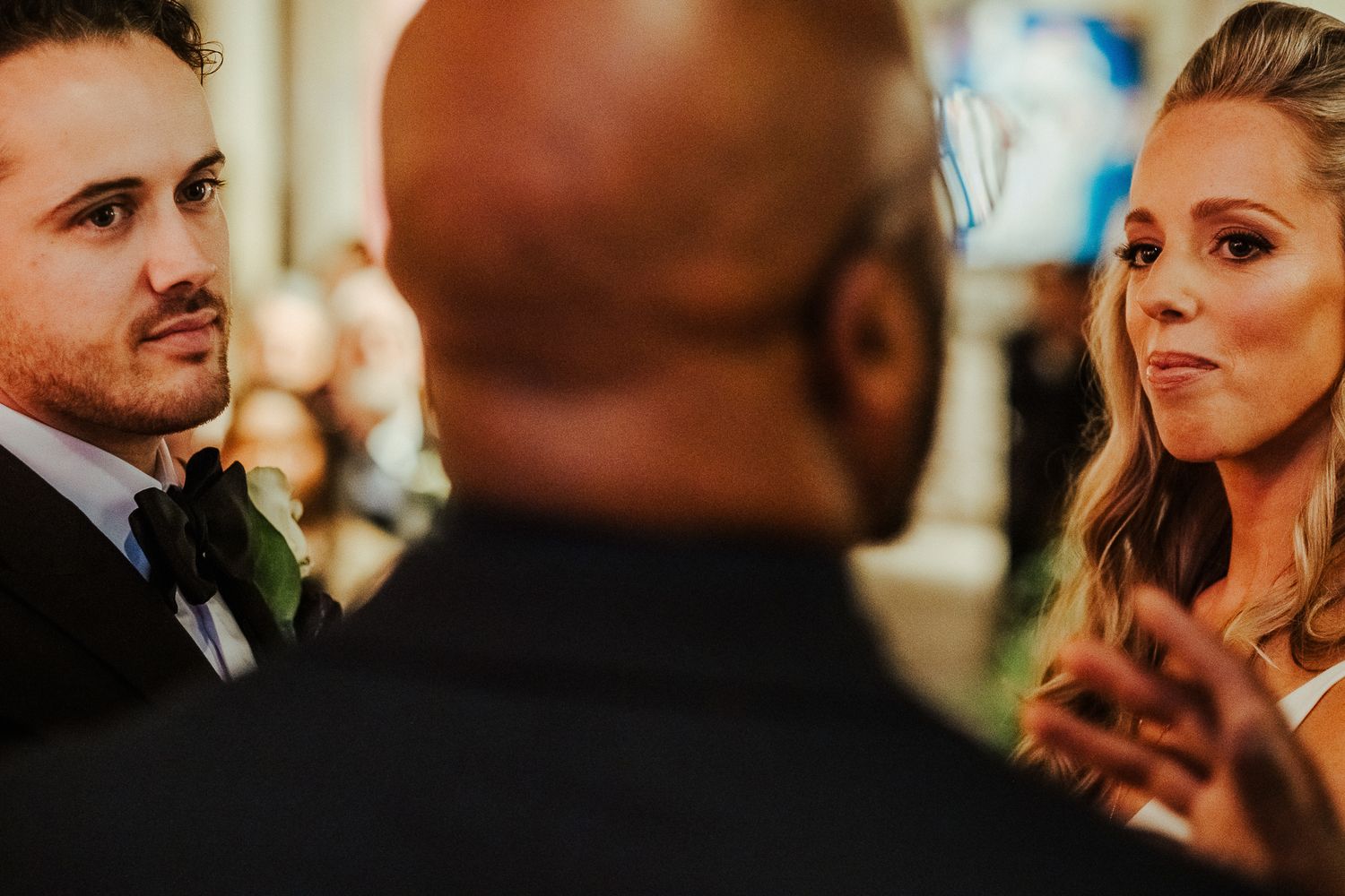 Guests engaged in animated conversation during elegant wedding reception.