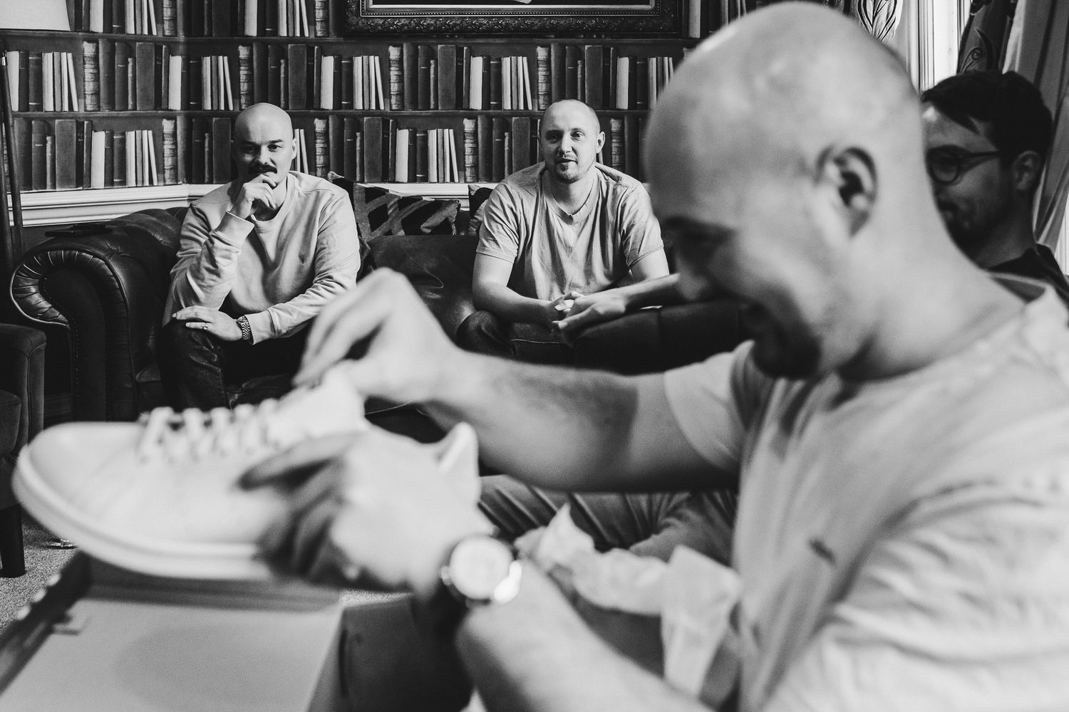 Documentary-style black and white photo of a casual gathering.