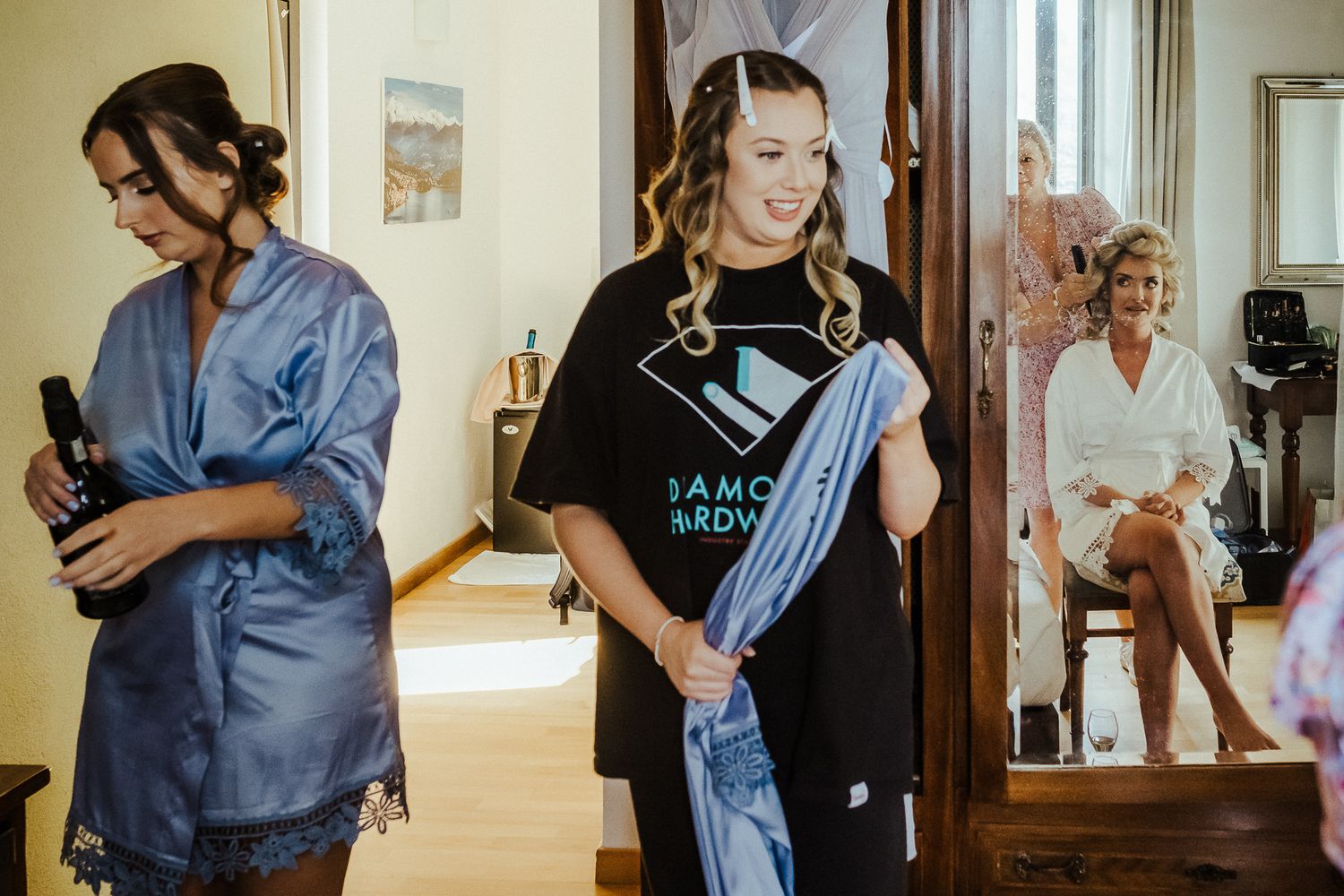 Behind the scenes of wedding preparations with stylists working in a bright room.