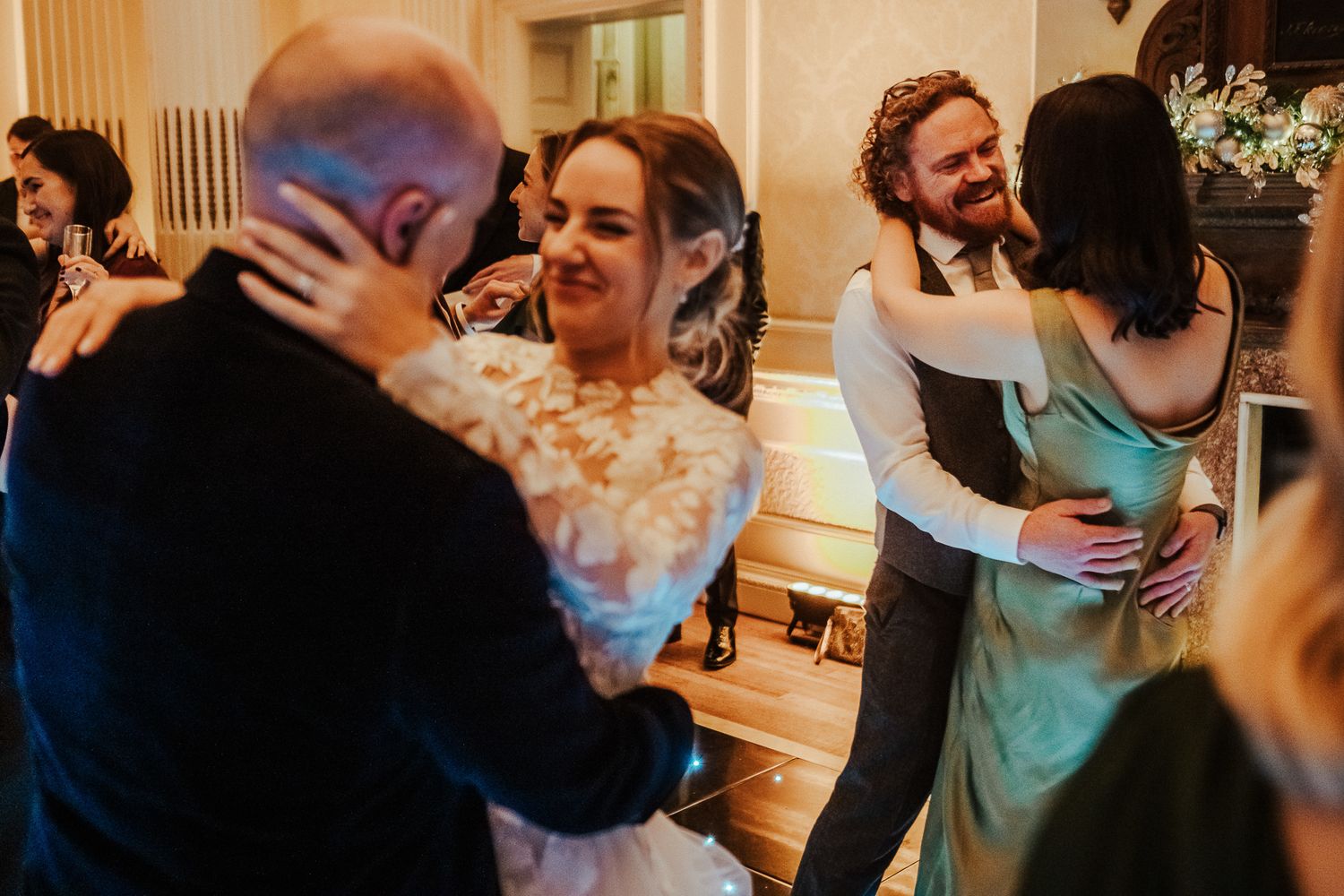 Joyful candid moments shared between guests during wedding reception festivities.