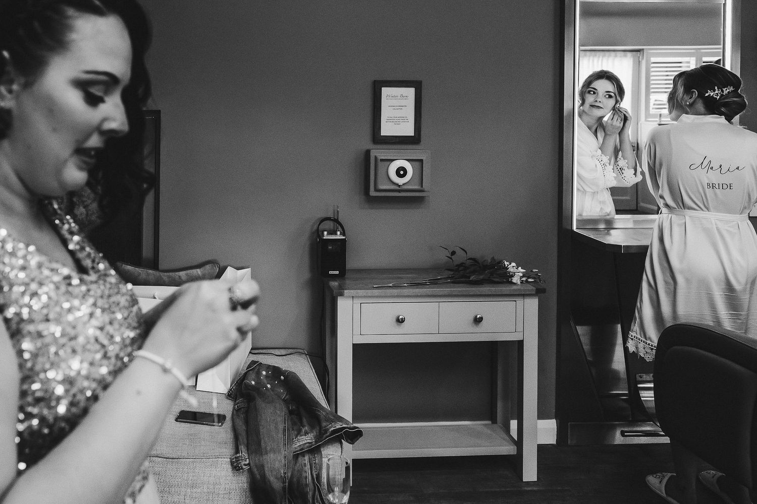 Behind-the-scenes wedding preparation moment in monochrome.