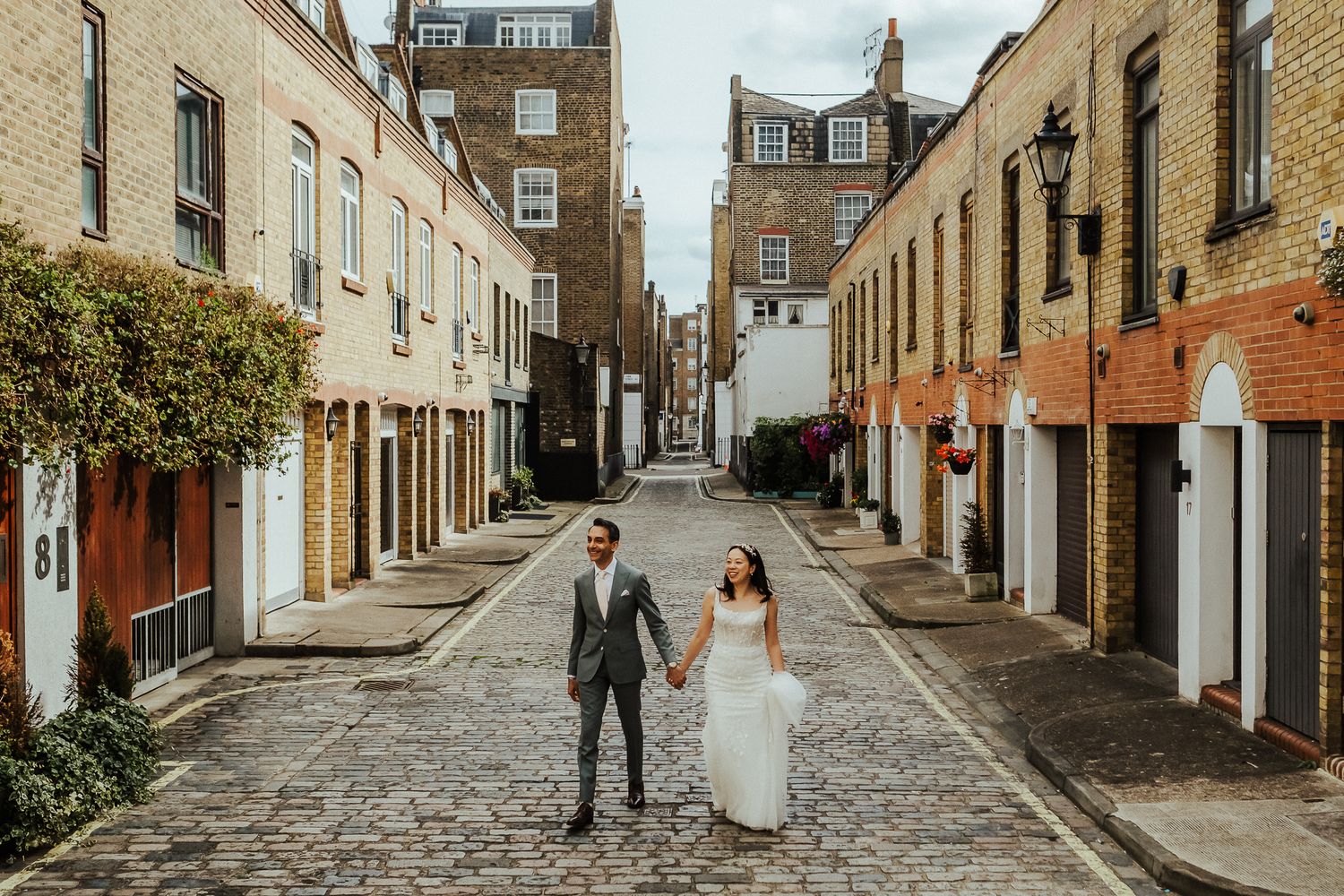 Cobblestone streets and historic buildings create romantic backdrop for wedding day photos.
