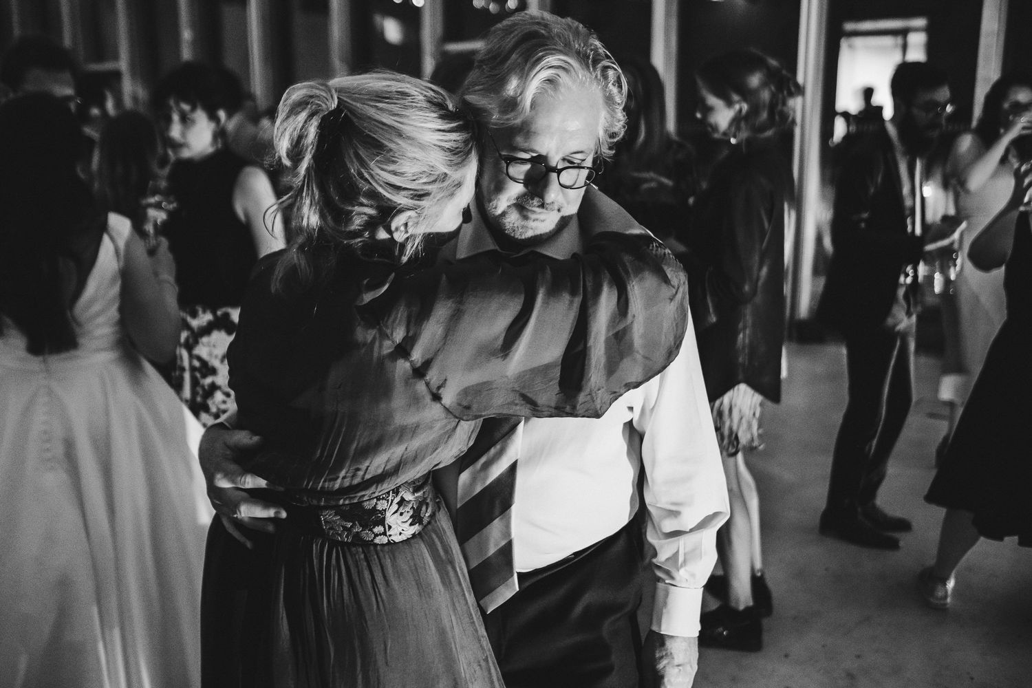 Couple shares an intimate slow dance in black and white photography.