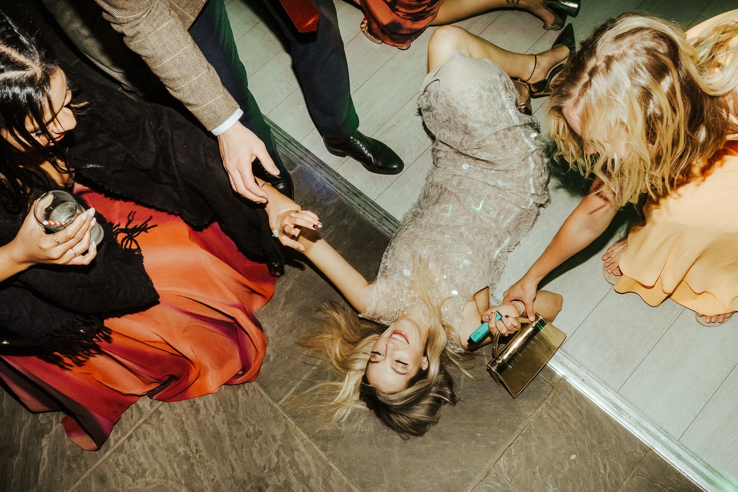 Wedding guests dance and celebrate on the dance floor during a reception party.