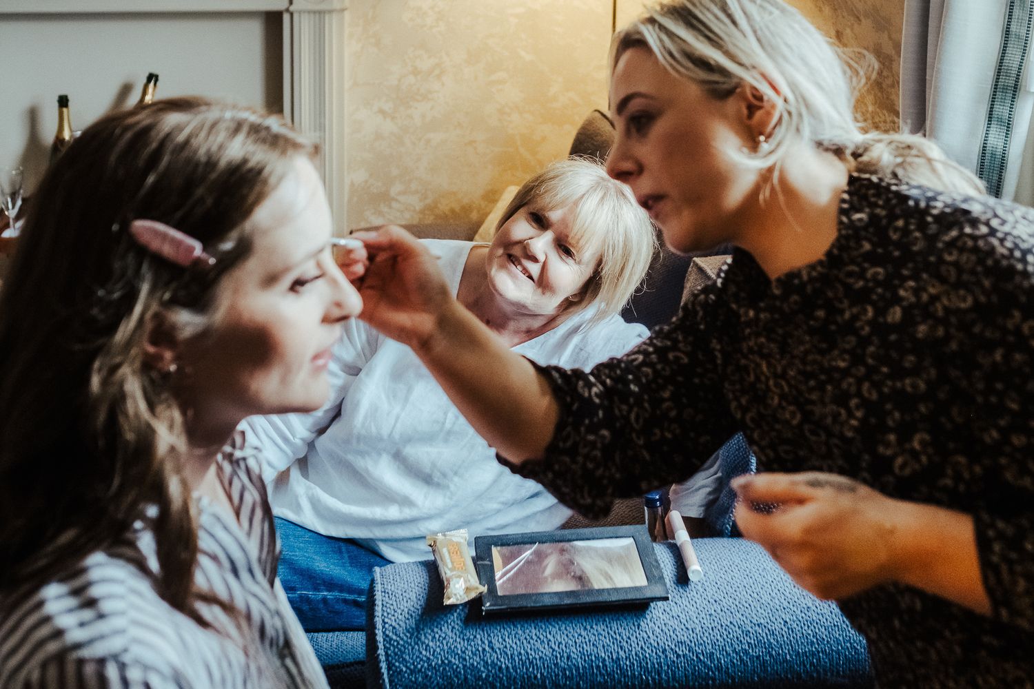 Candid moments shared during wedding day preparations.