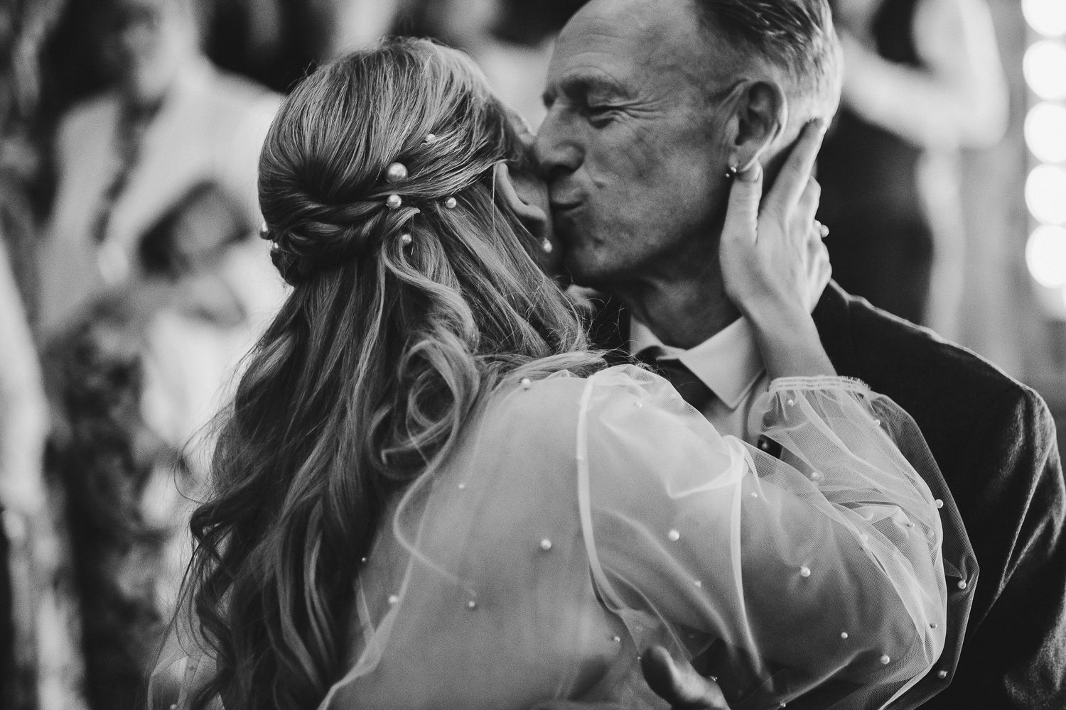 Intimate black and white wedding portrait capturing romantic moment.