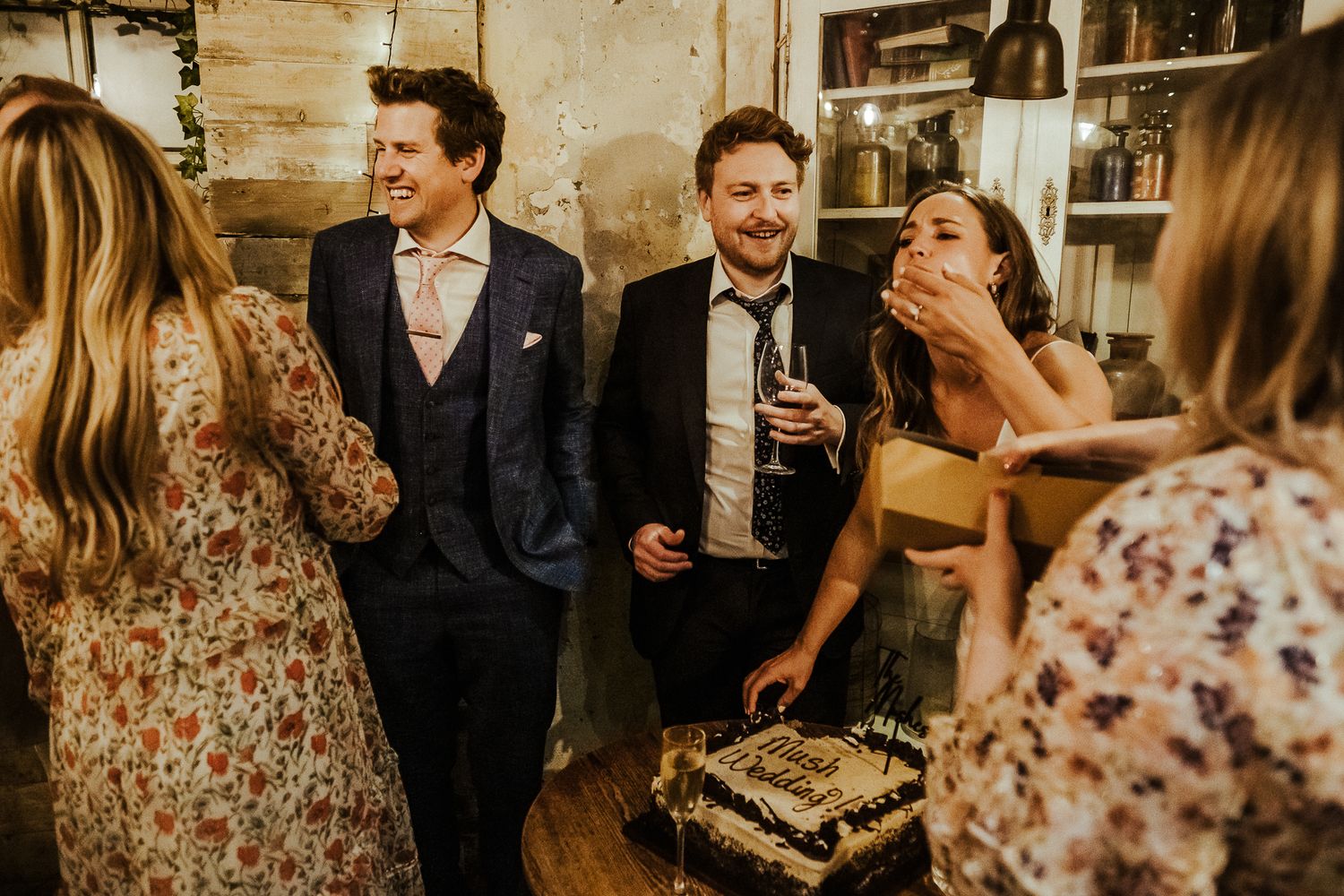 Guests enjoying cocktails and conversation at an intimate indoor wedding reception.