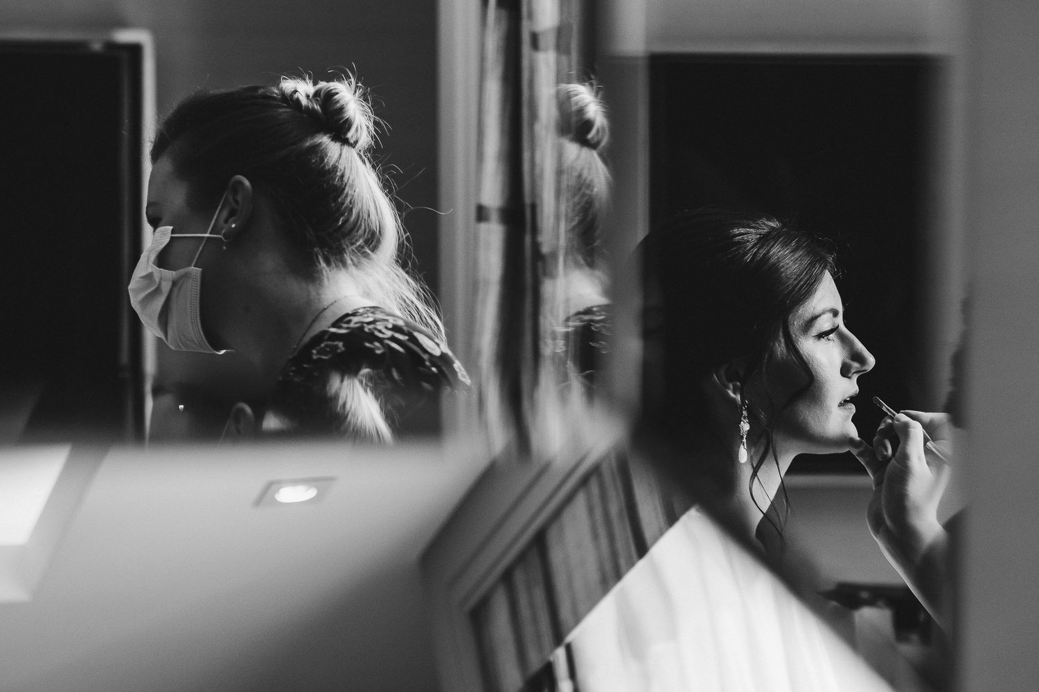 Romantic black and white wedding day preparations with soft window lighting.