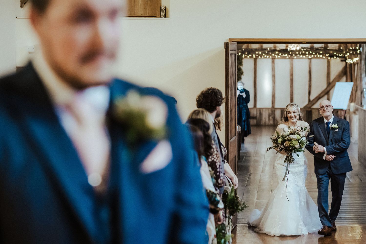 First look moment captured through mirror reflection in wedding venue.