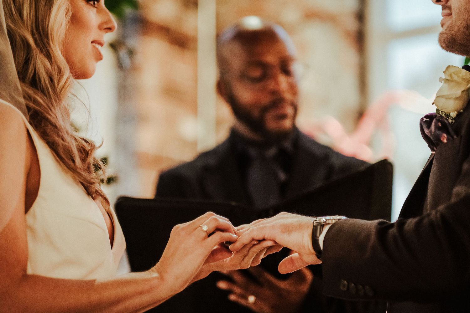 Exchange of rings during intimate wedding ceremony moment.
