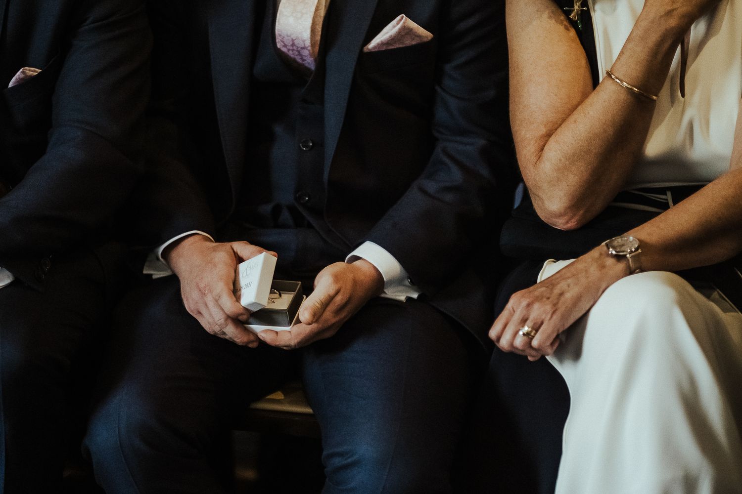 Wedding party members seated together during reception festivities.