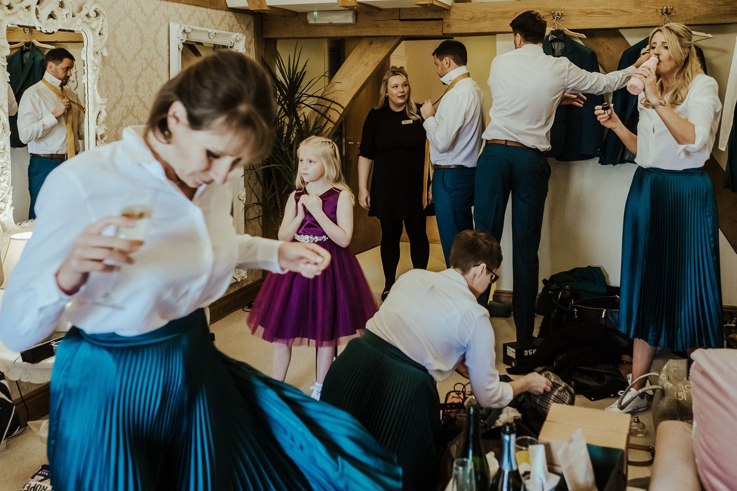 People dancing and celebrating at casual indoor wedding reception.