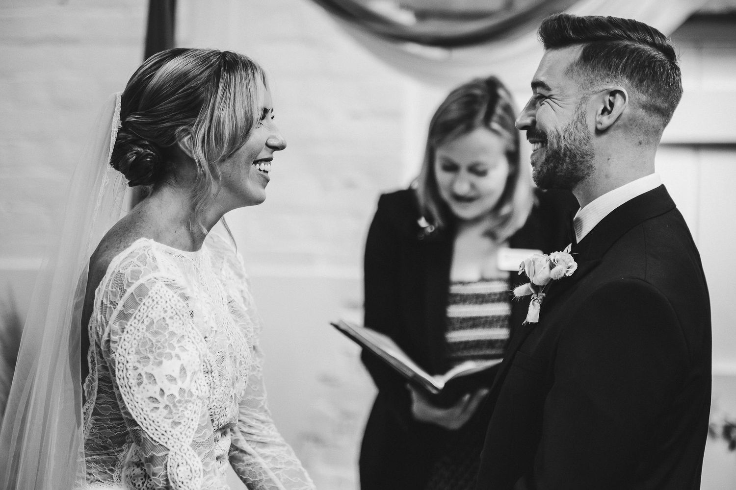 Wedding ceremony moment captured in intimate indoor setting.