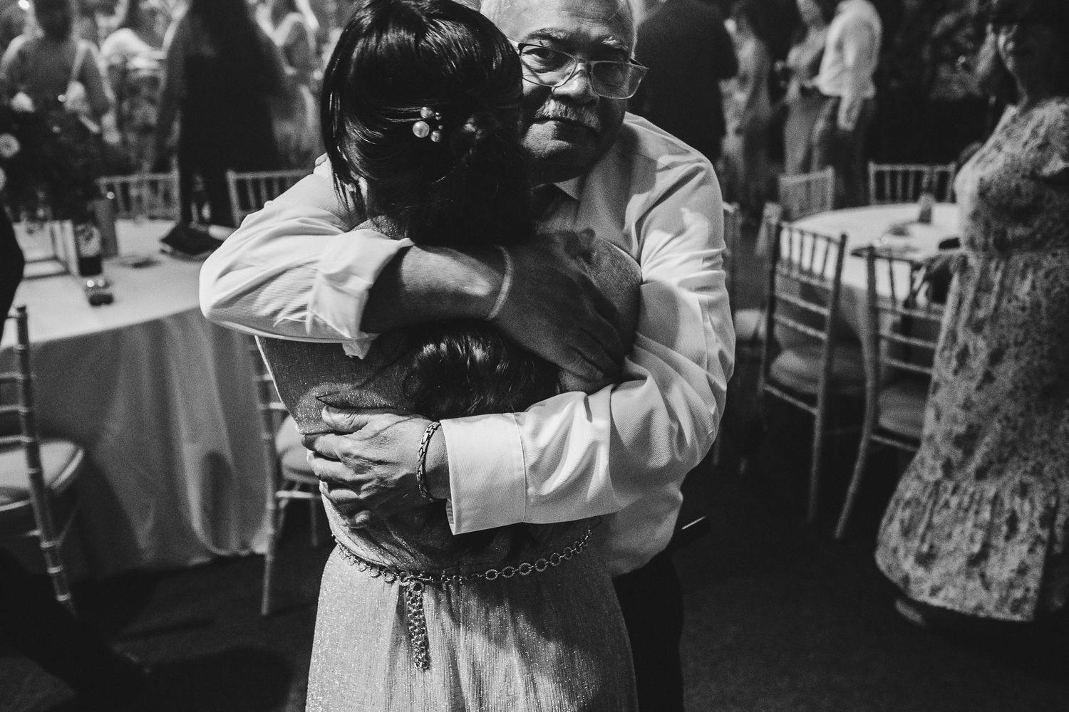 Couples dancing together at an elegant reception event captured in vintage black and white photography.