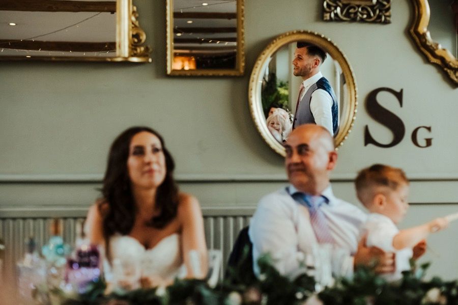 Wedding reception venue decorated with elegant mirrors and vintage decor.