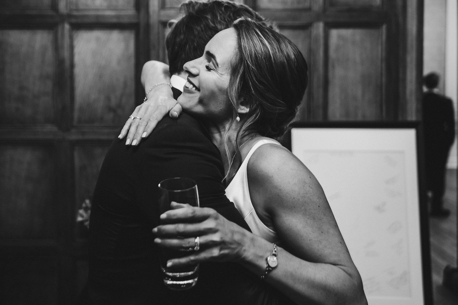 Black and white captures of natural laughter and joy during wedding reception conversations.