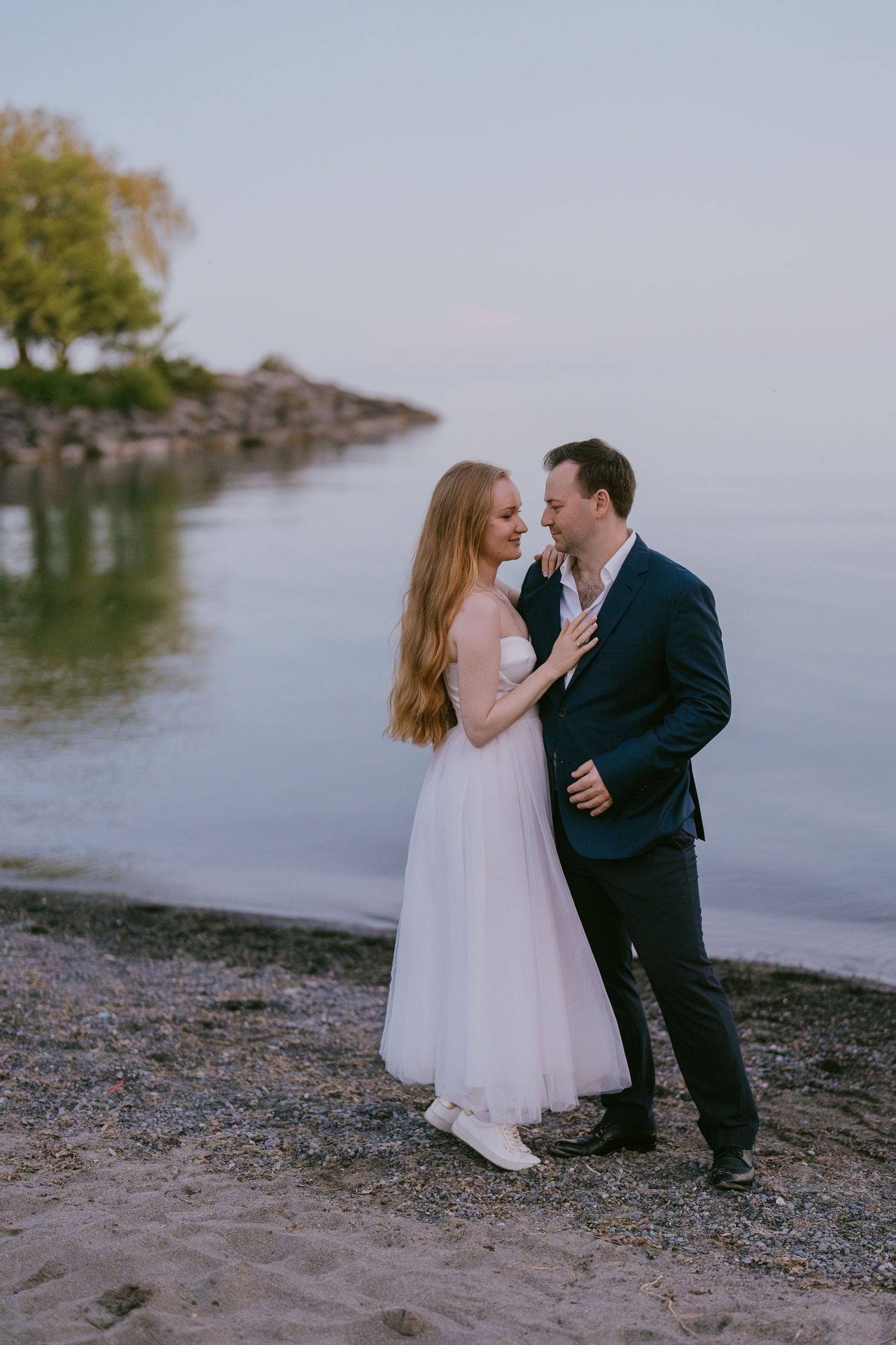 Romantic wedding couple portrait by the lake at golden hour in Toronto